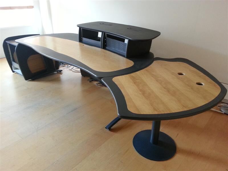 Curved wooden edit suite desk with rack unit housing